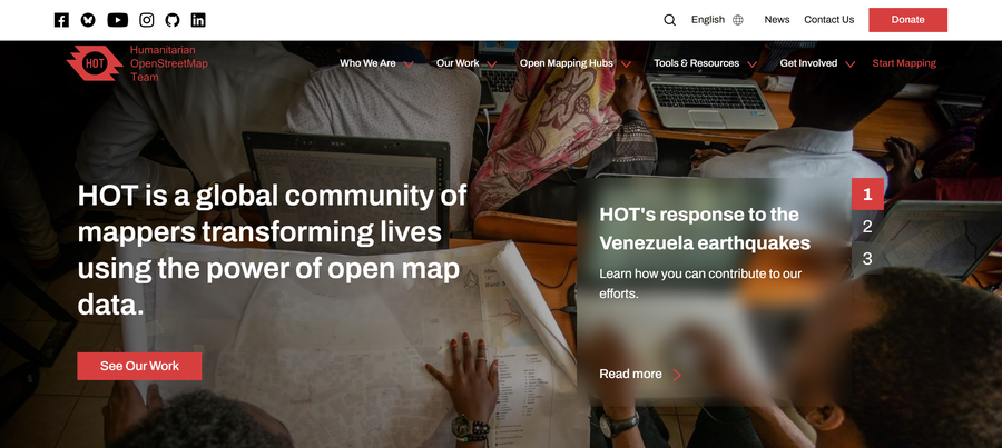 The Humanitarian OpenStreetMap Team homepage. The headline reads HOT is a global community of mappers transforming lives using the power of open map data, over a photograph of people working with laptops and paper maps around a table. A panel highlights HOT's response to the Venezuela earthquakes.