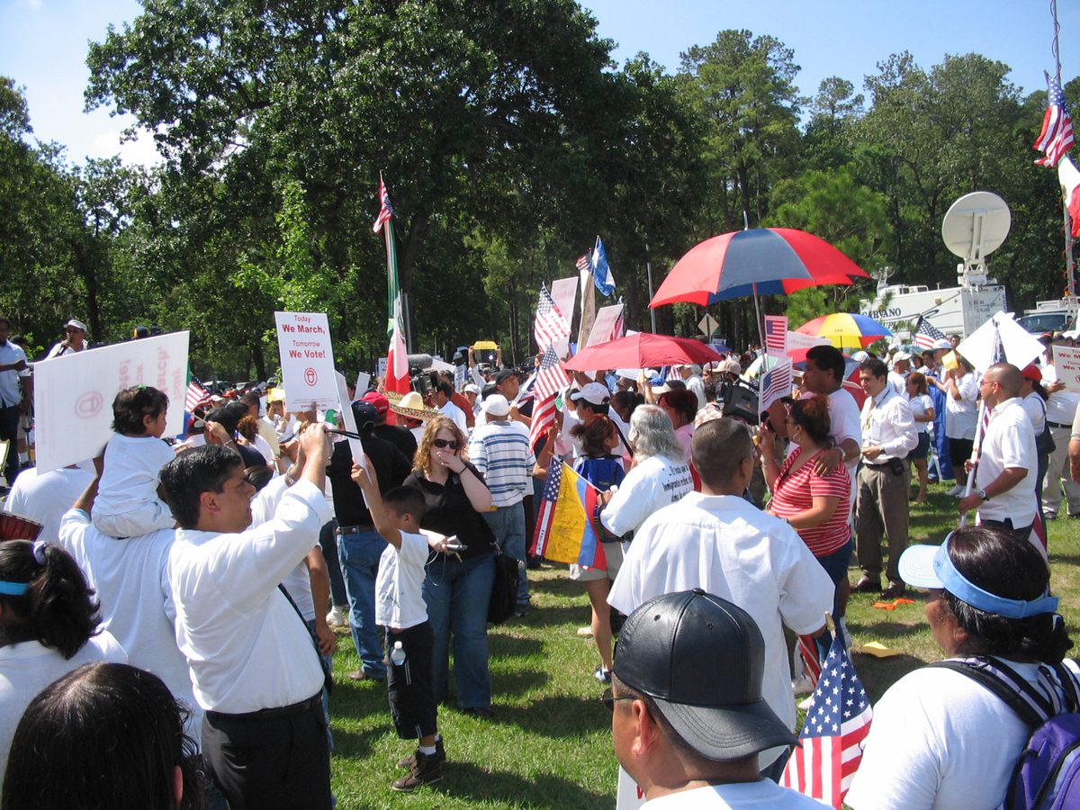 A protester holds a sign reading 'Today we march, tomorrow we vote' at a 2006 immigrant rights march
