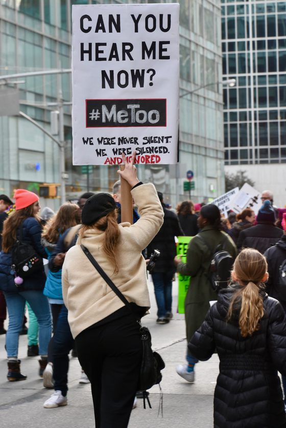 A demonstrator at the 2018 Women's March holds a sign reading hashtag MeToo